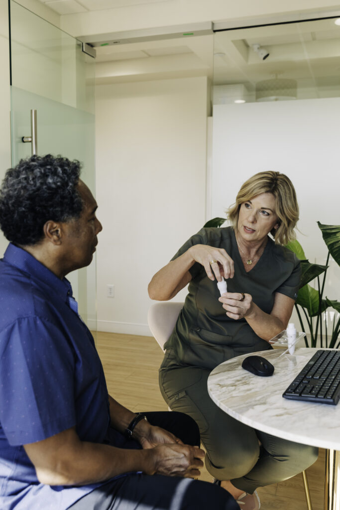 Dr. Dickerson zirconia dental implant consultation Denver Dr. Sharon Dickerson discussing metal-free zirconia dental implant options with a patient at her Denver biological dental office
